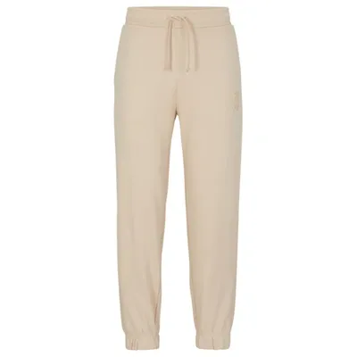 Hugo Relaxed-fit Cotton-terry Tracksuit Bottoms With Stacked Logo In Light Beige