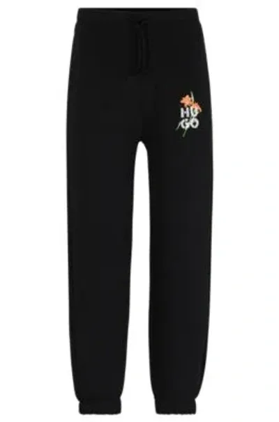 Hugo Relaxed-fit Tracksuit Bottoms With Floral Logo Artwork In Black