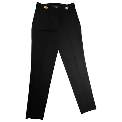 Pre-owned Ferragamo Wool Trousers In Black