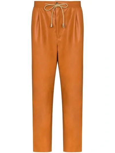 Nanushka Tuan Faux Leather Track Pants In Orange